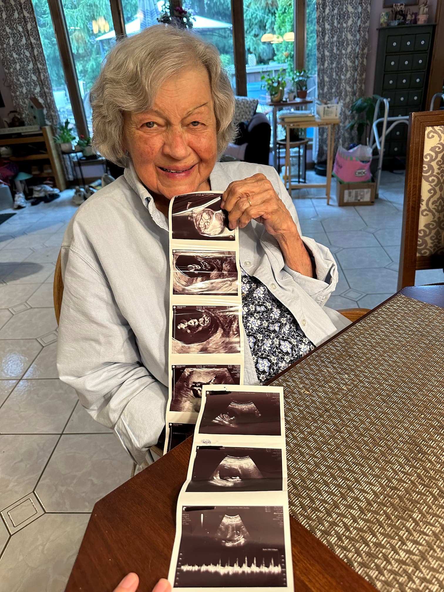 Grandma Mary holding ultrasound pictures of her second great-grandchild